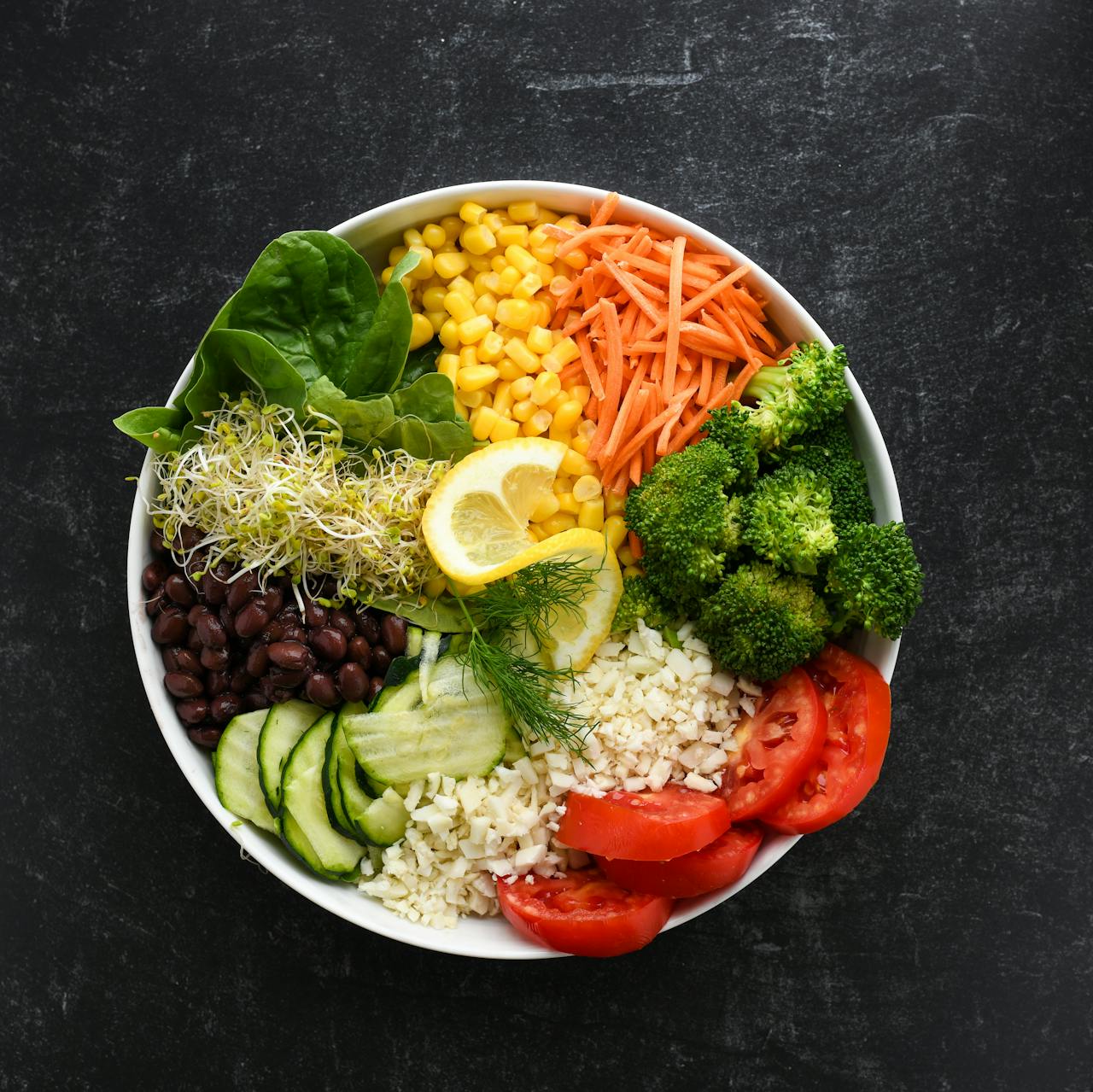 Top view of a vibrant salad bowl with fresh vegetables for a healthy meal.
